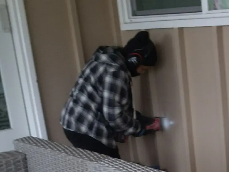 Professional electrician installing an exterior outlet in Kaplan